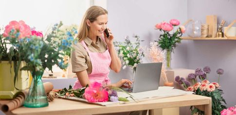 Kukkakauppayrittäjä puhelimessa